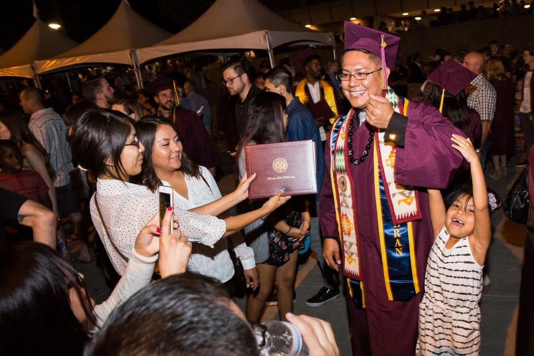 graduate greeting his family after convocation