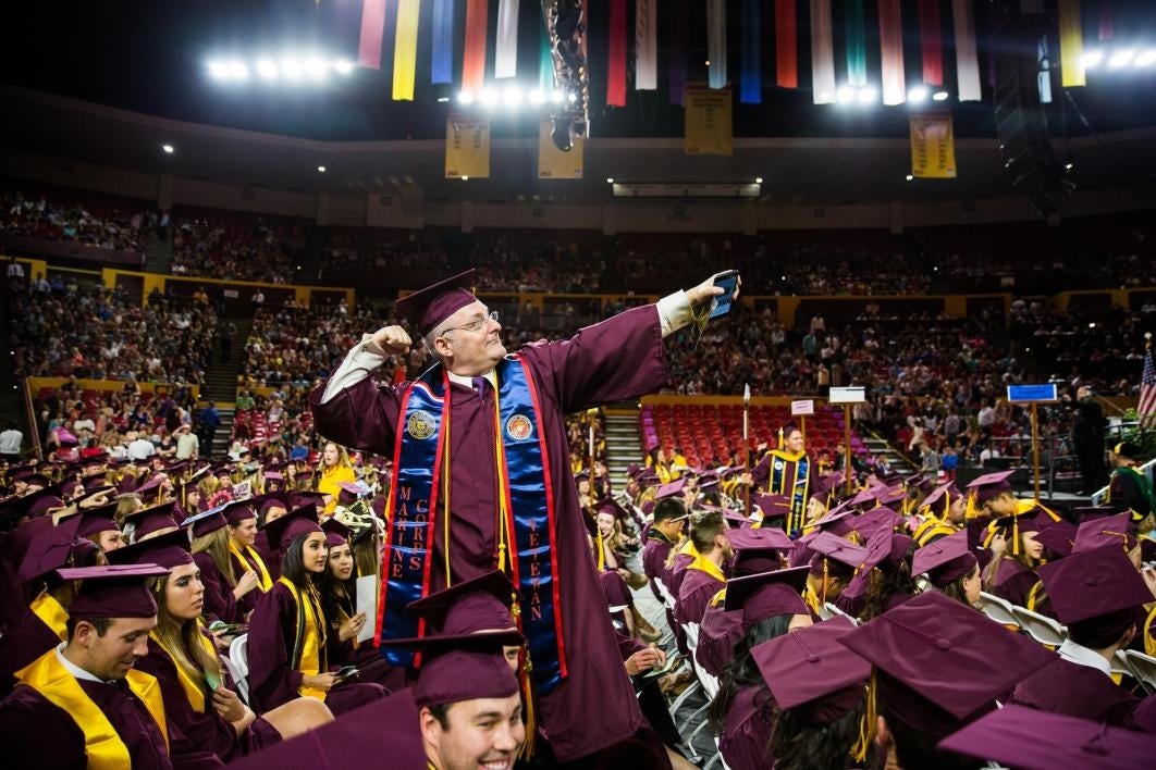 graduate showing off in the stands