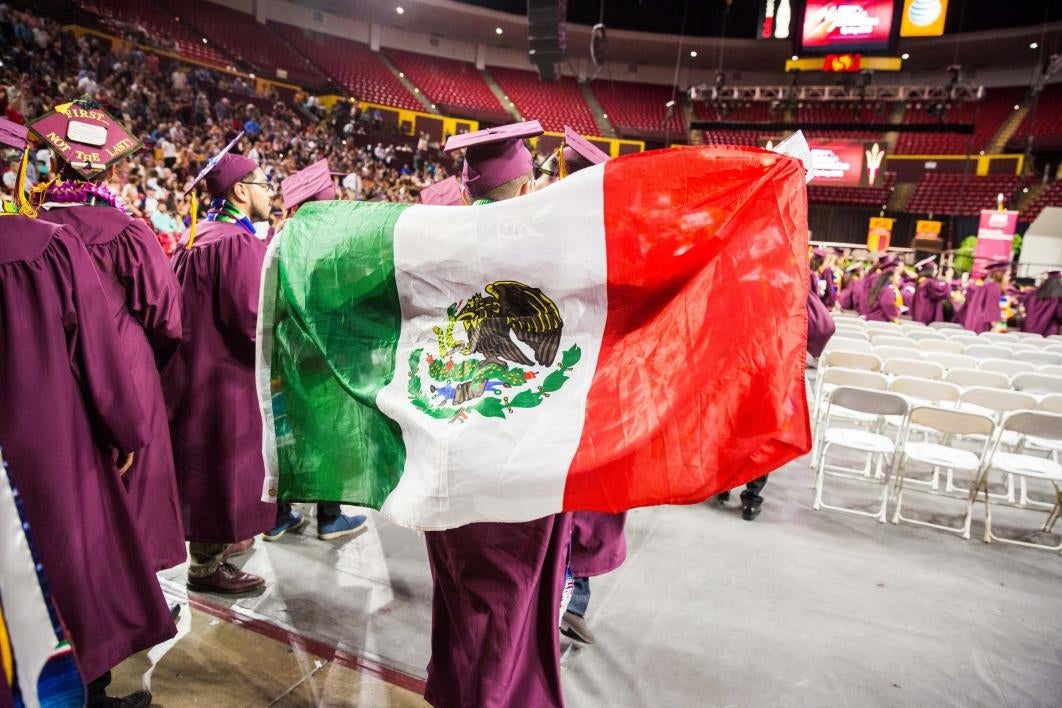 graduates entering Wells Fargo arena