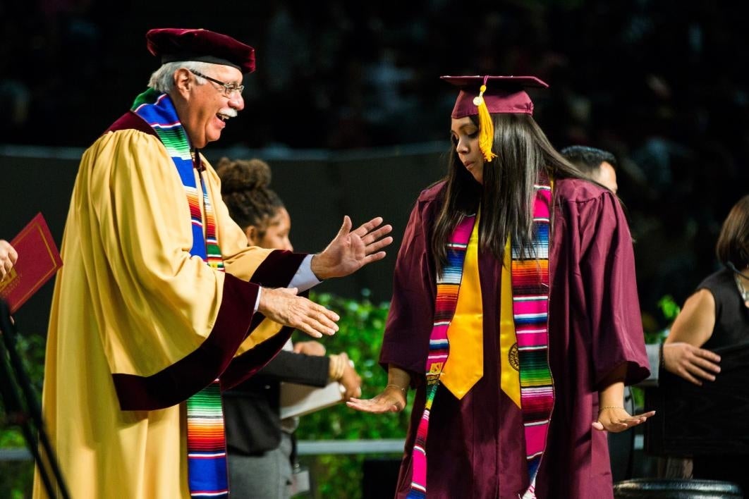 graduate dancing on stage at convocation