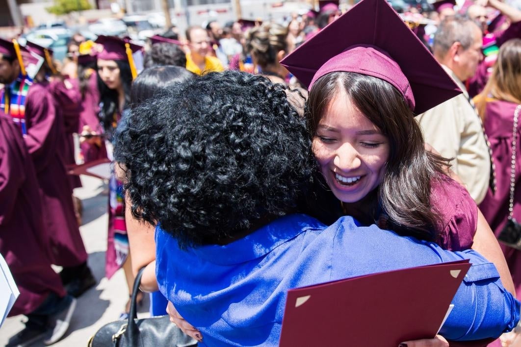 friend hugging graduate