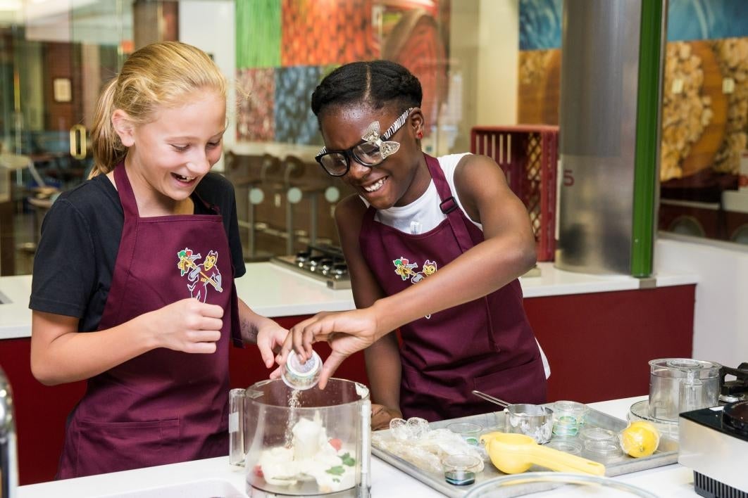 Two young students learn to cook at Camp Crave