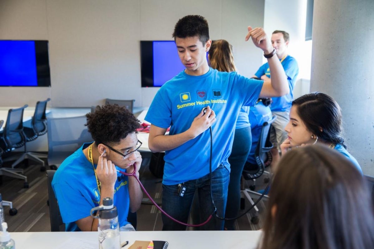 student shows others how to use a stethoscope