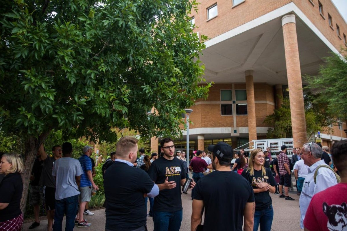 group of people talking outside