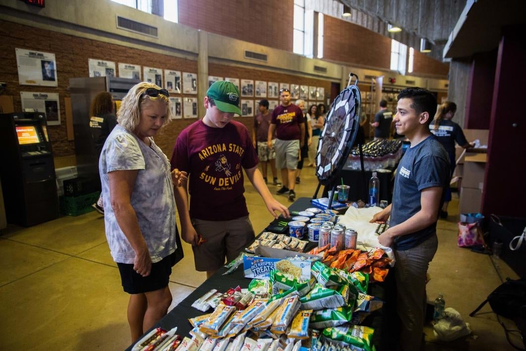 mom and son looking at table with snacks