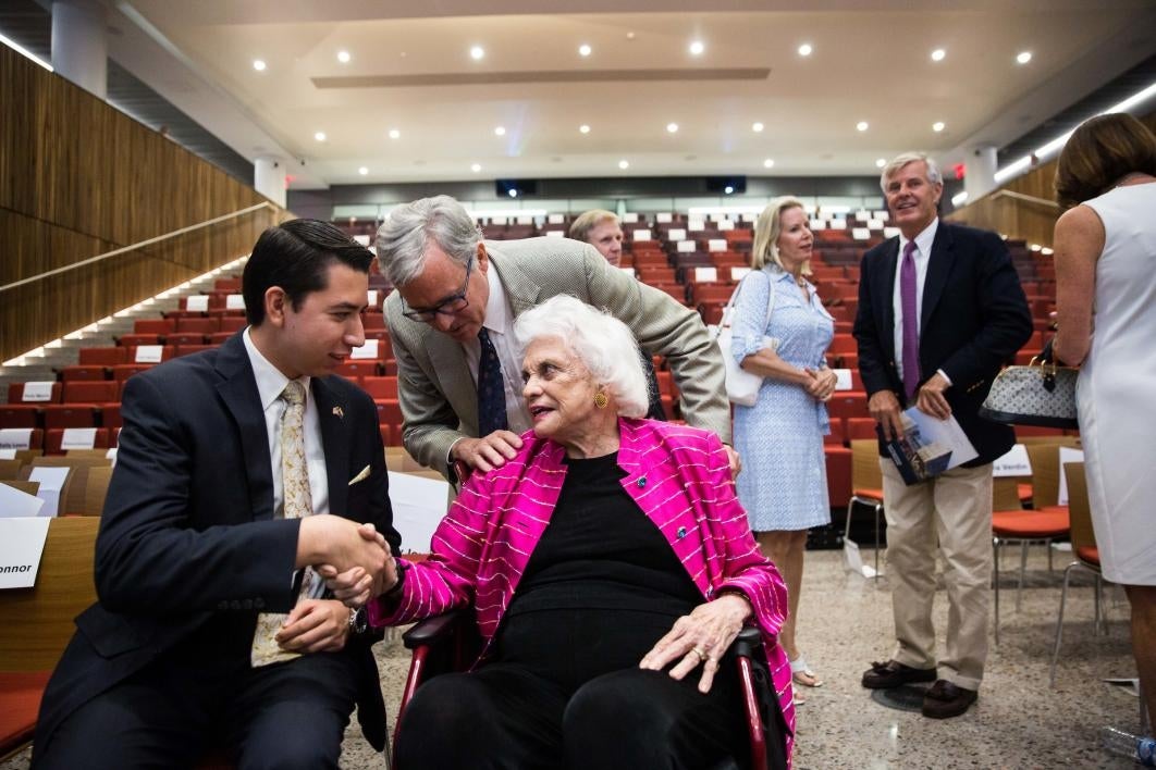 Sandra Day O'Connor speaks with a student after the law center opening.