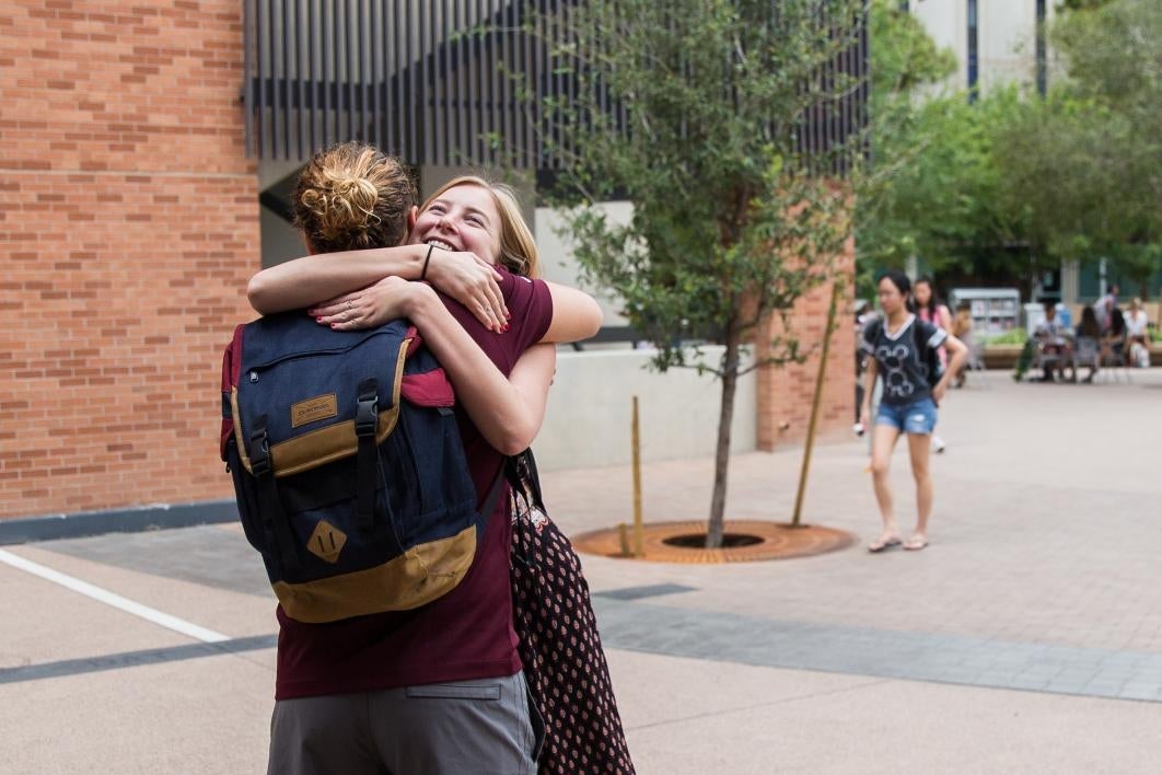 two students hugging