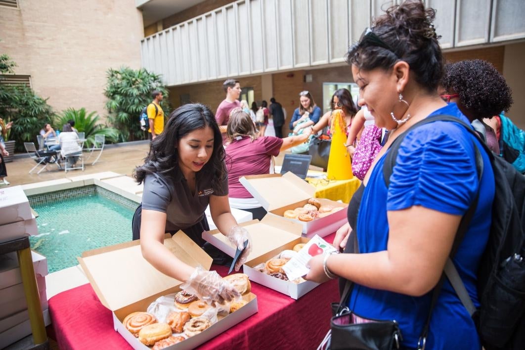 students taking donuts