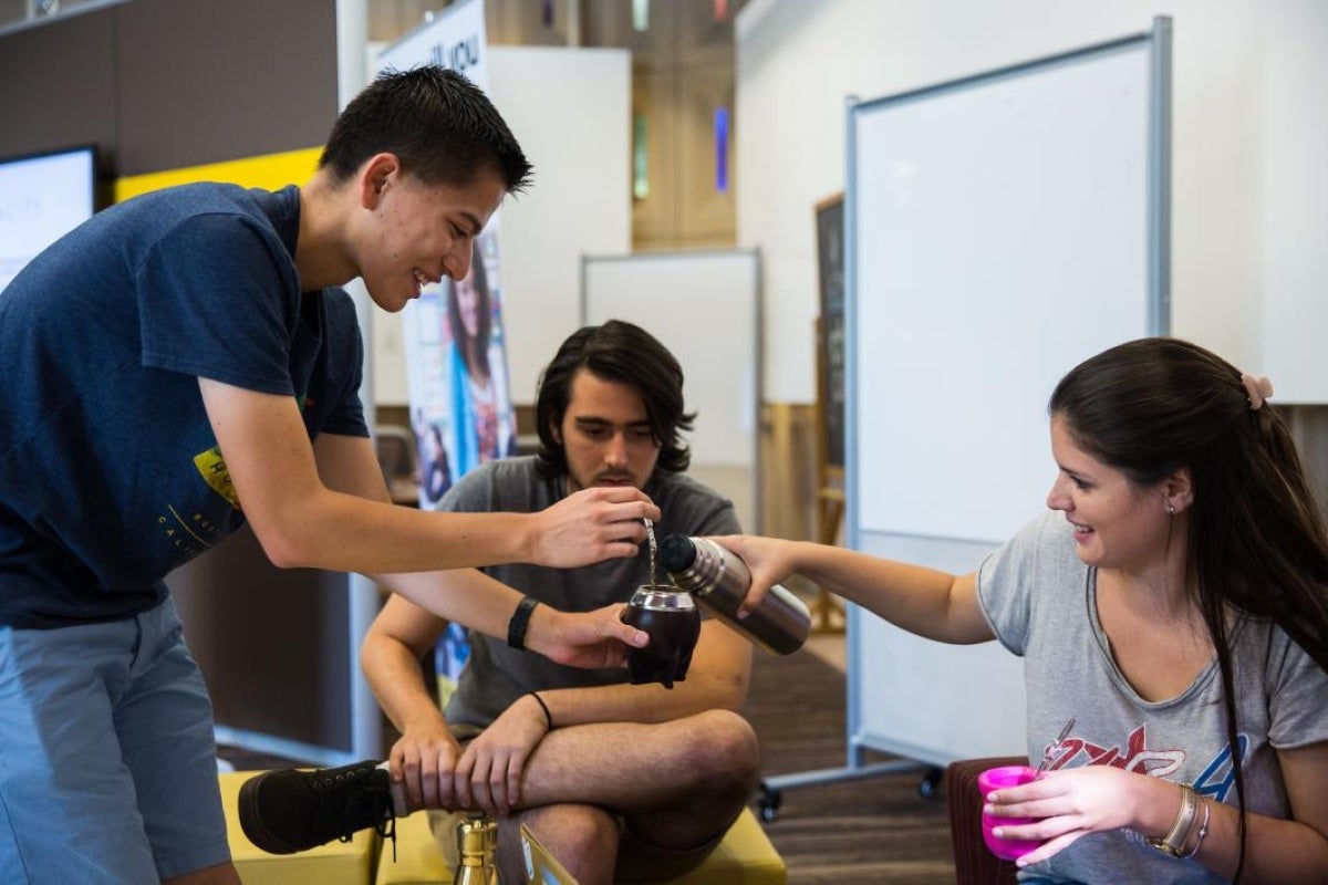 students sharing thermos of yerba mate