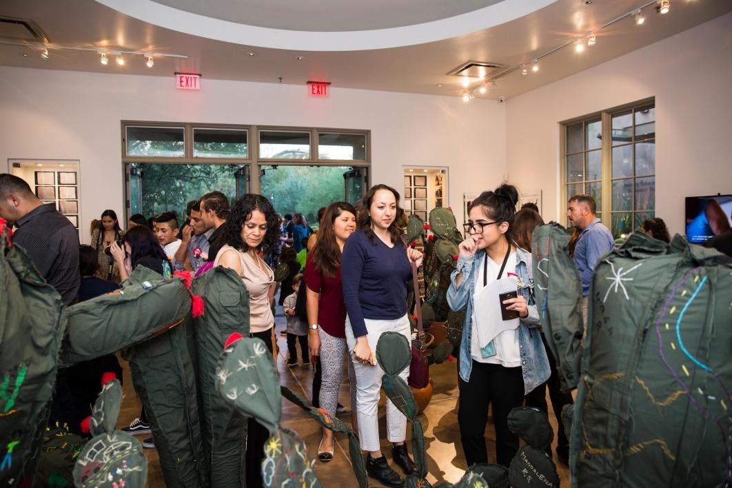 Guests explore the cloth-cactus exhibit.