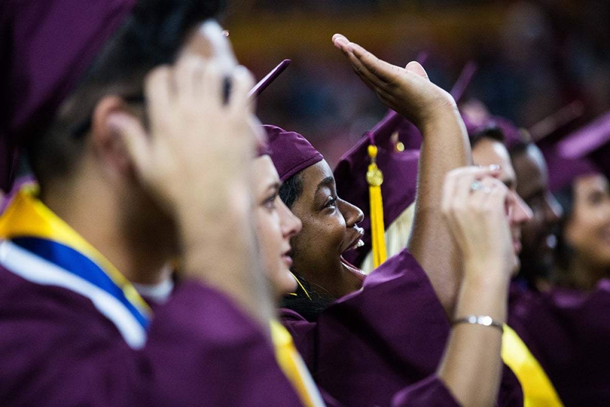 Grads wave to their families