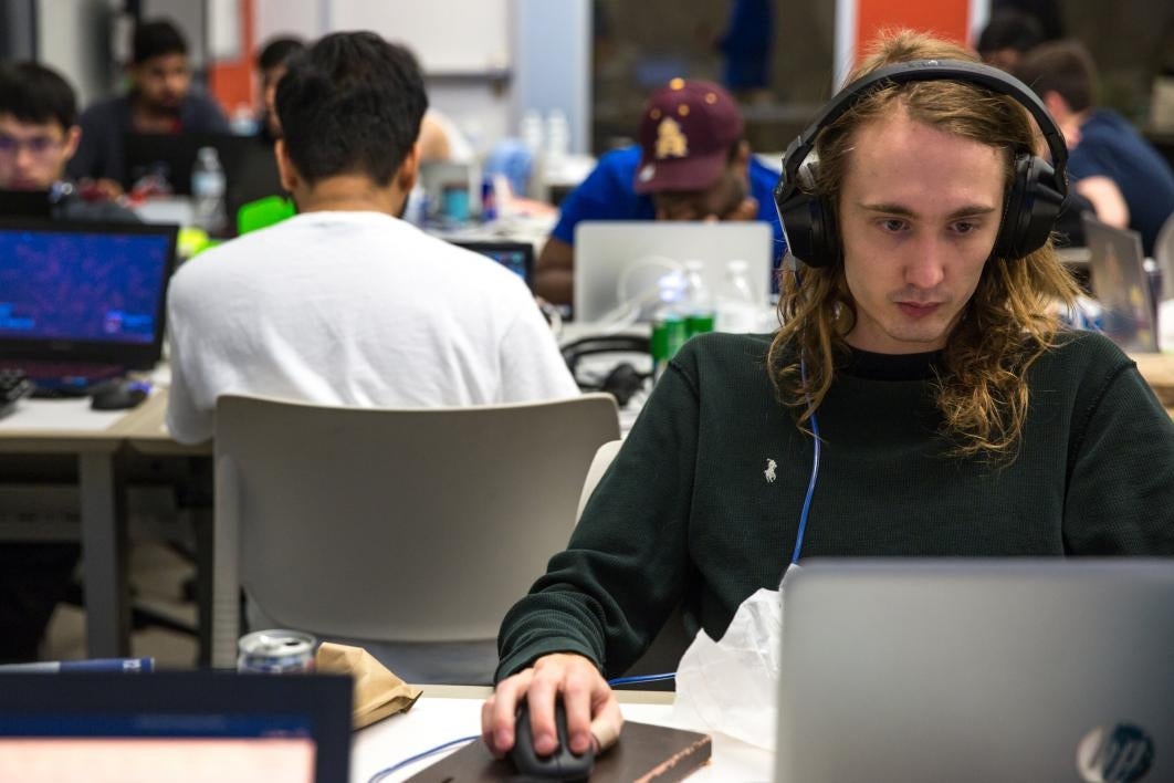 A student coder works during the hackathon