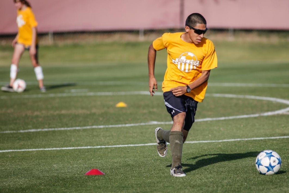 student playing soccer