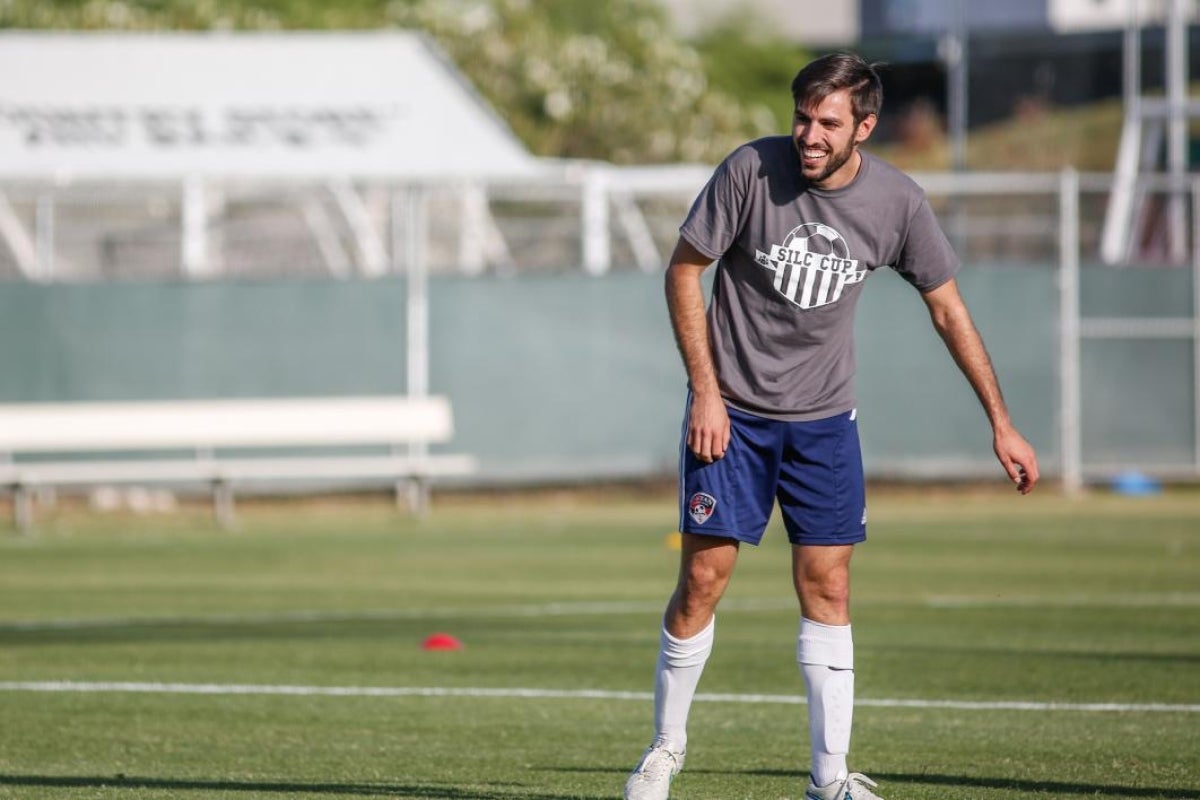 man laughing on soccer field