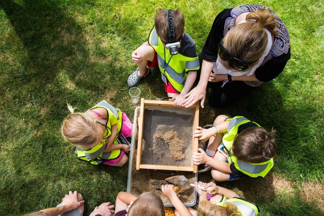 kids digging through sand for candy