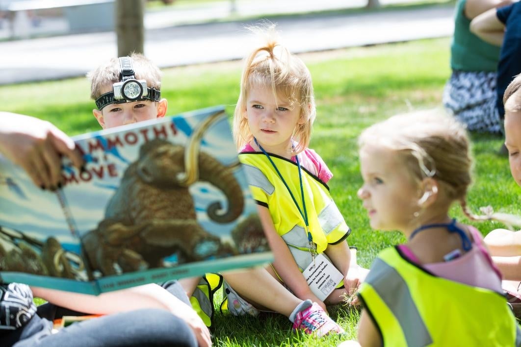 kids listening to a book being read to them