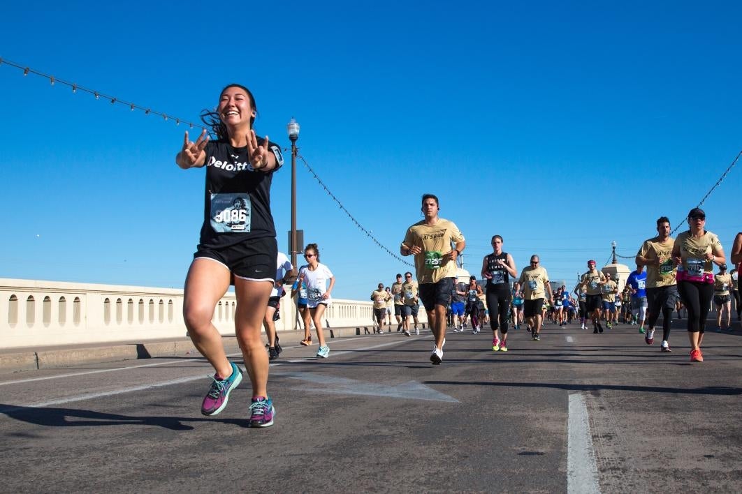 A runner flashes a pitchfork gesture during the 2017 Pats Run