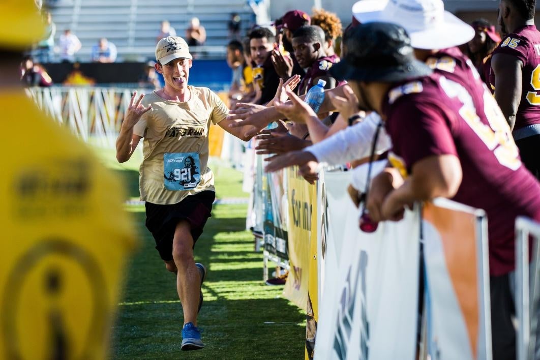 ASU football players greet runners as they finish Pat's Run