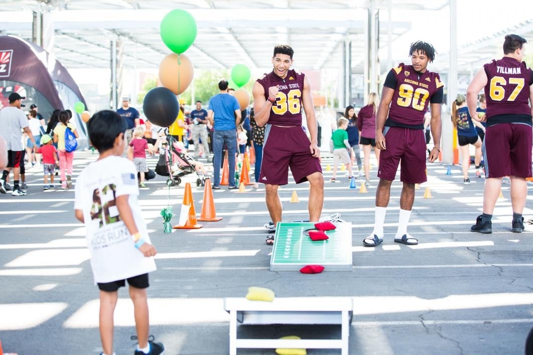 Kids play bean toss after Pats Run