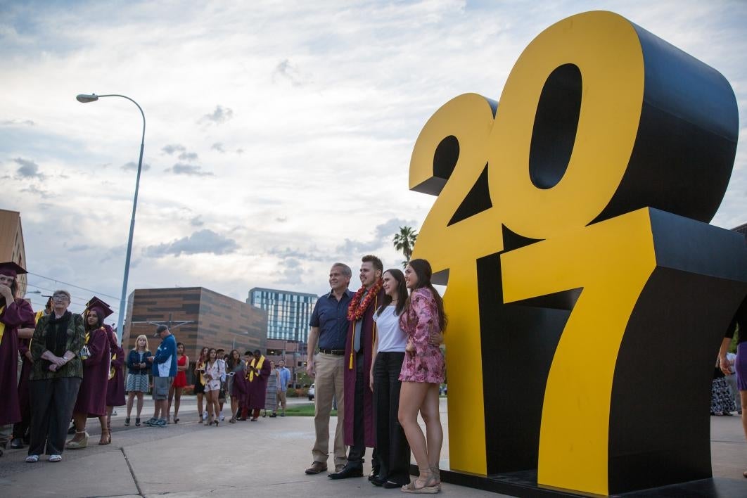 people standing in front of statue that says 2017