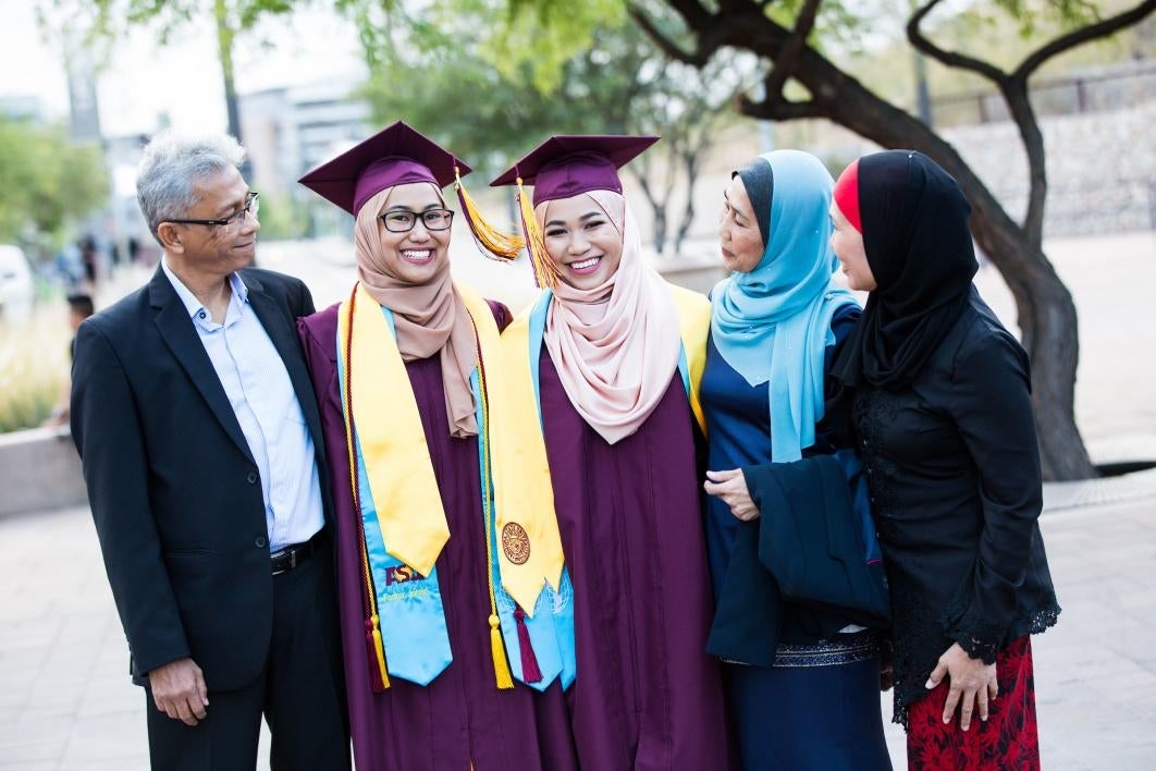 family taking photos before graduation