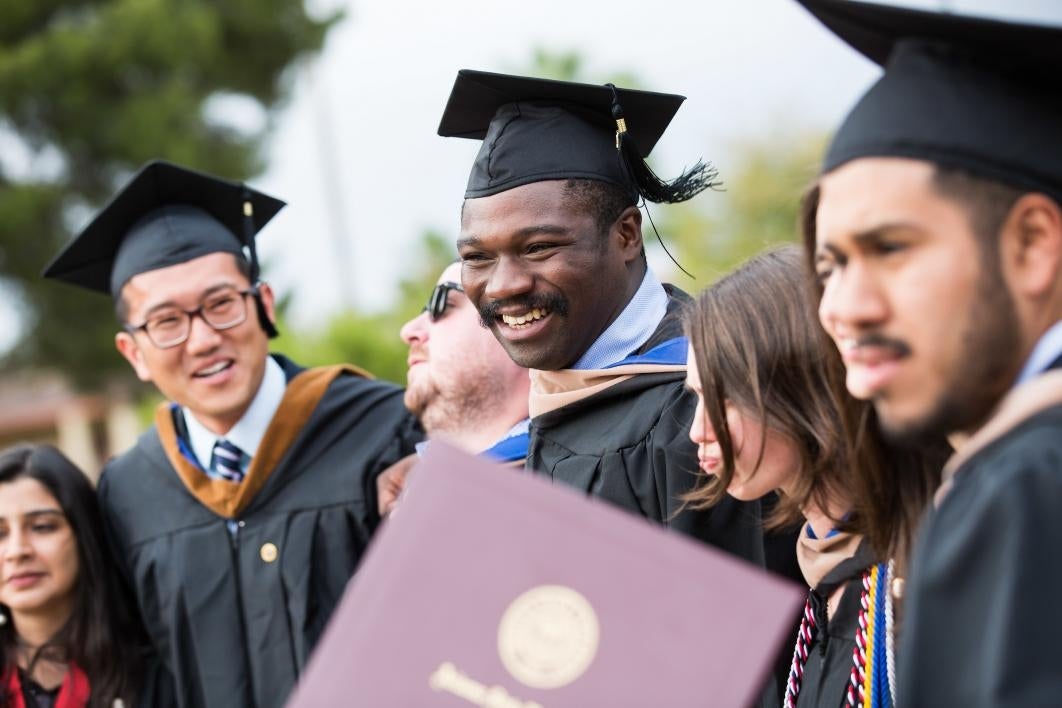 Graduates pose for photos after the Thunderbird School of Global Management commencement