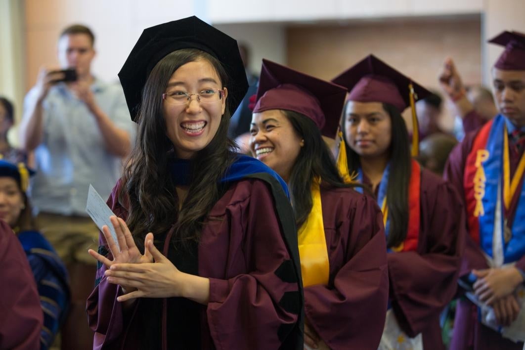 graduate walking down aisle