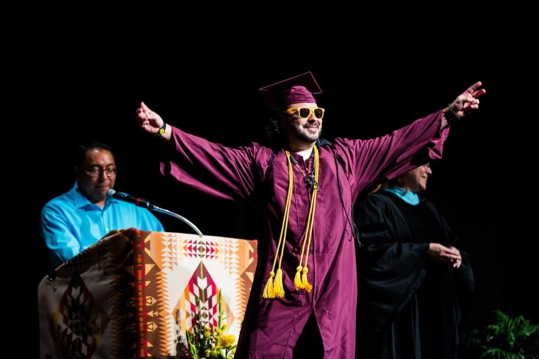 graduate crossing the stage