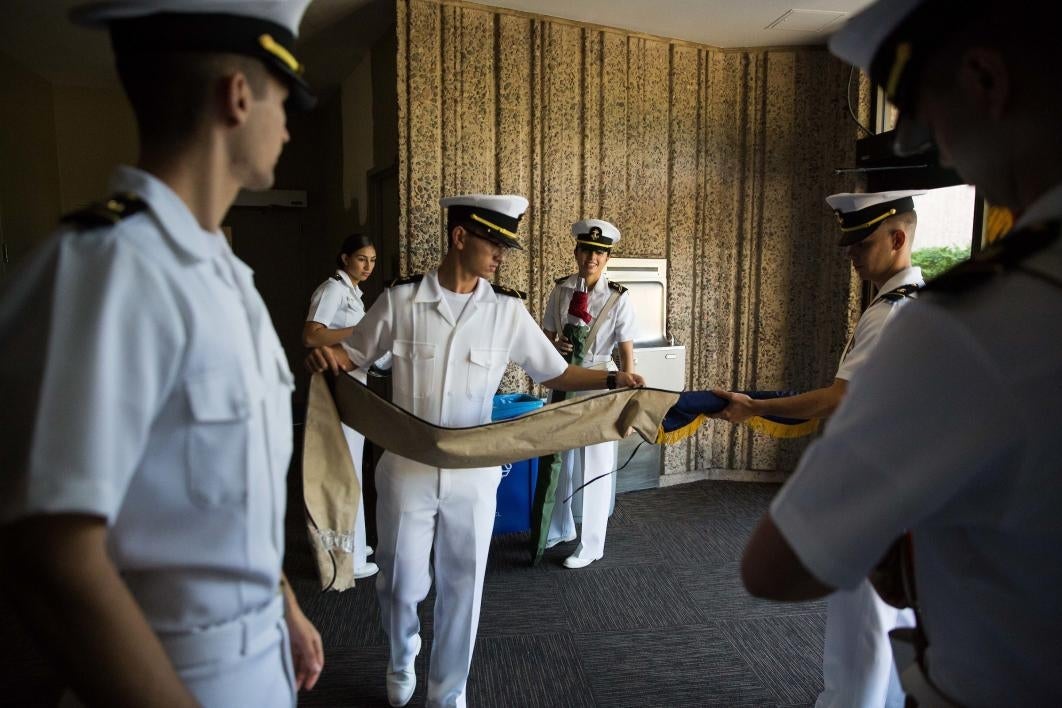 ROTC students folding flags