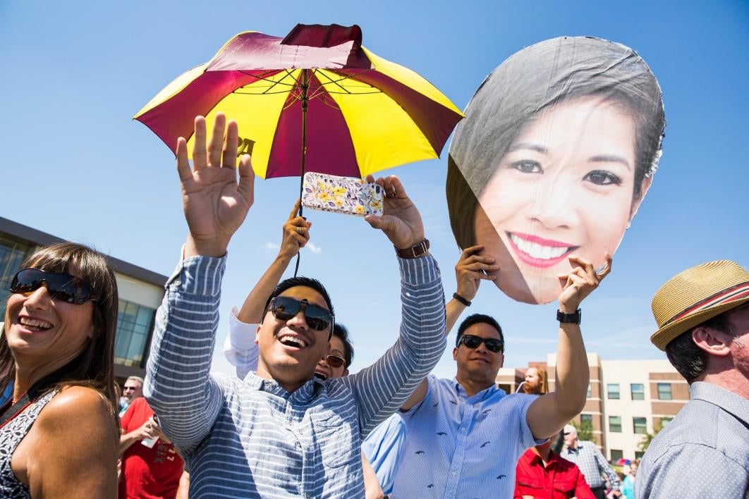 family cheering on graduate