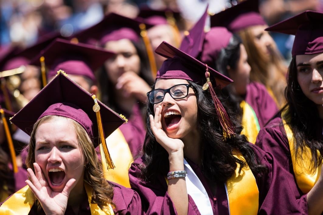 graduates cheering on friend