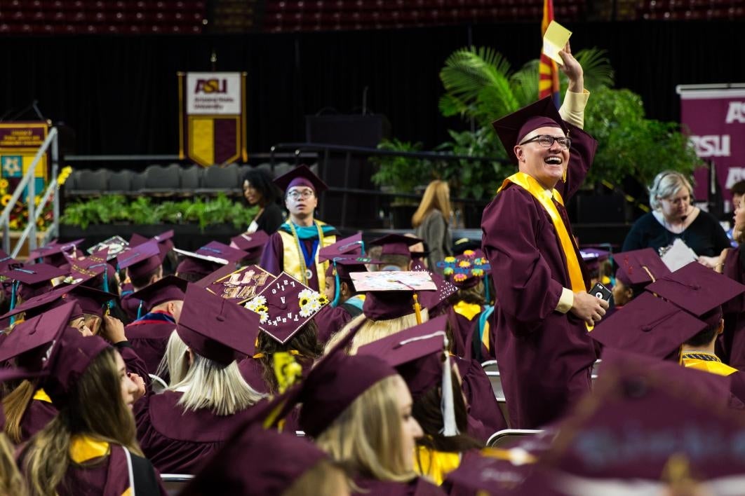 graduate waving to family