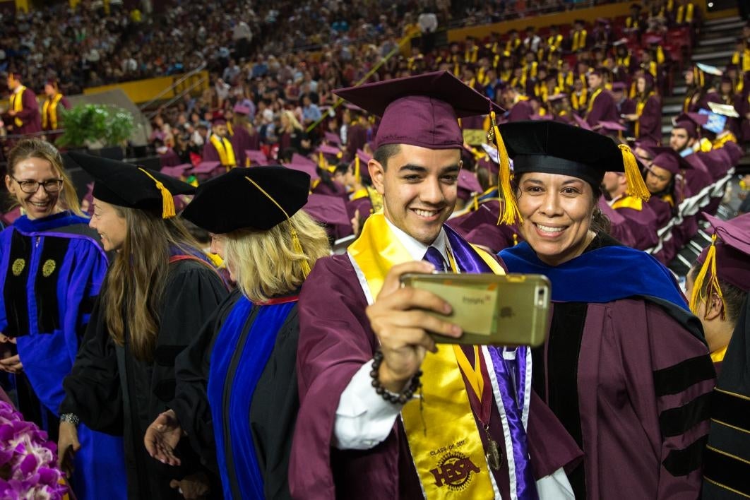 graduate and professor taking a photo