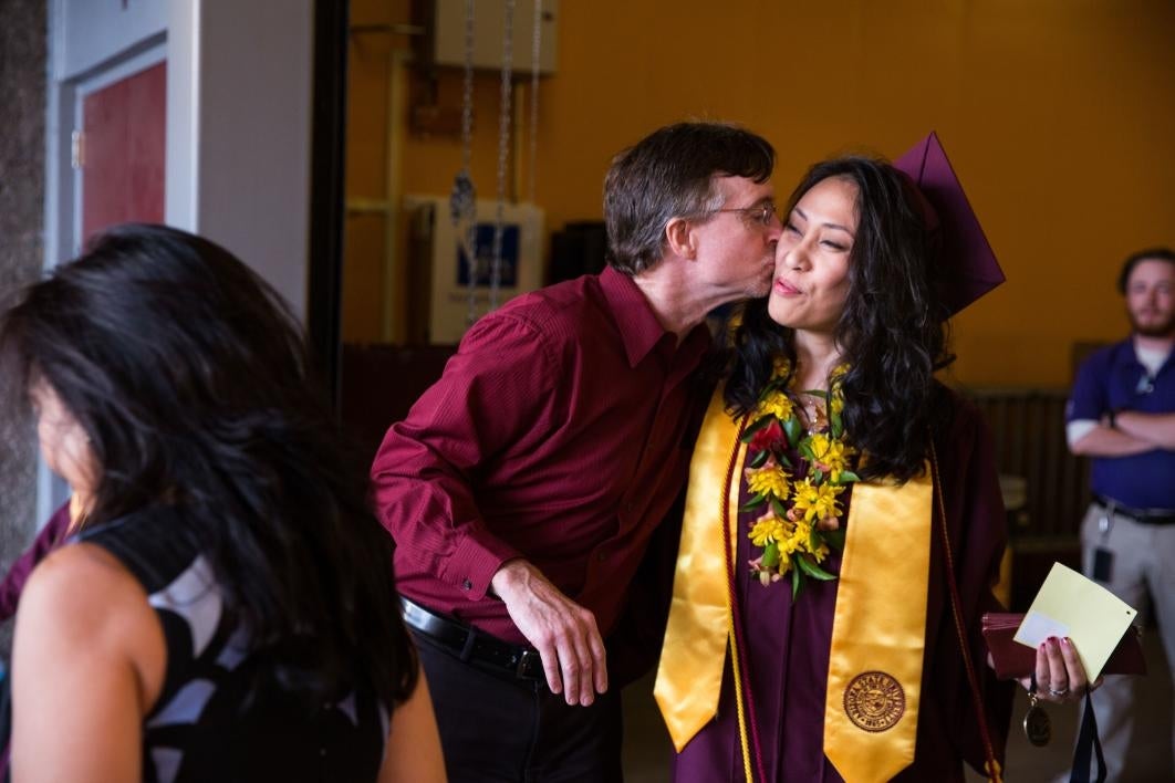 husband giving wife a kiss on the cheek