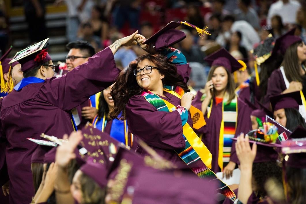 two grads dancing at convocation