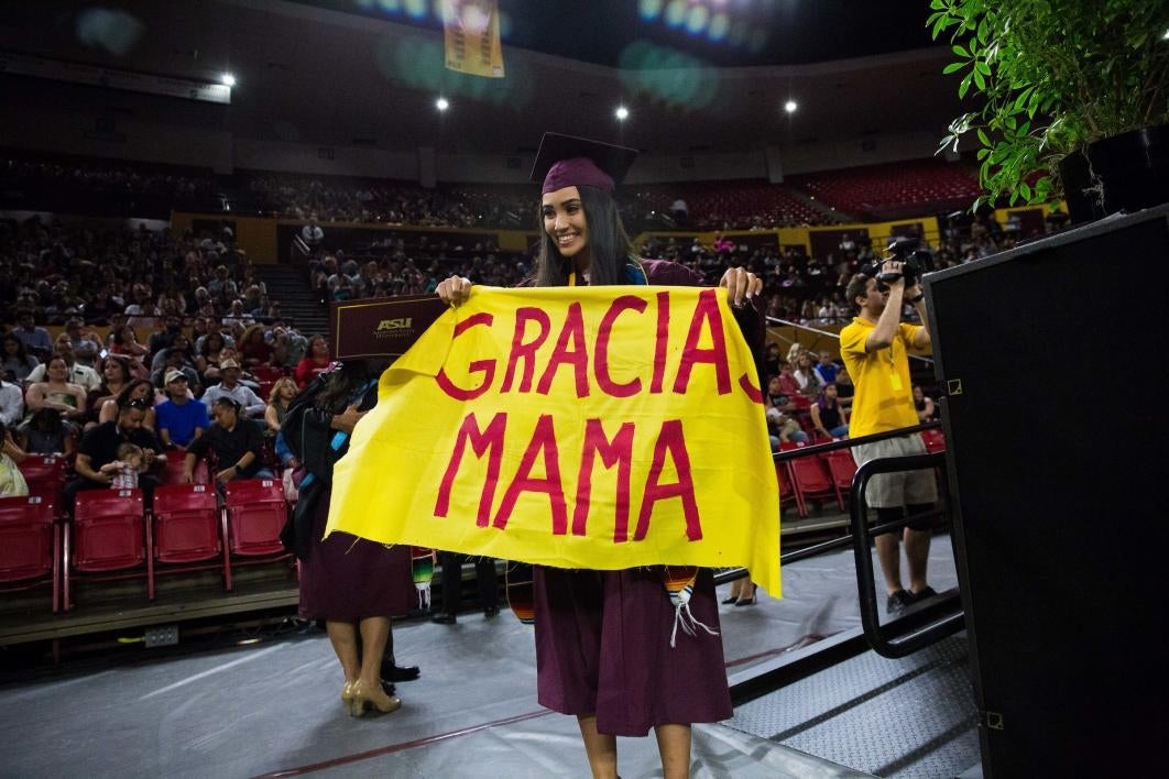 grad holding sign that says 