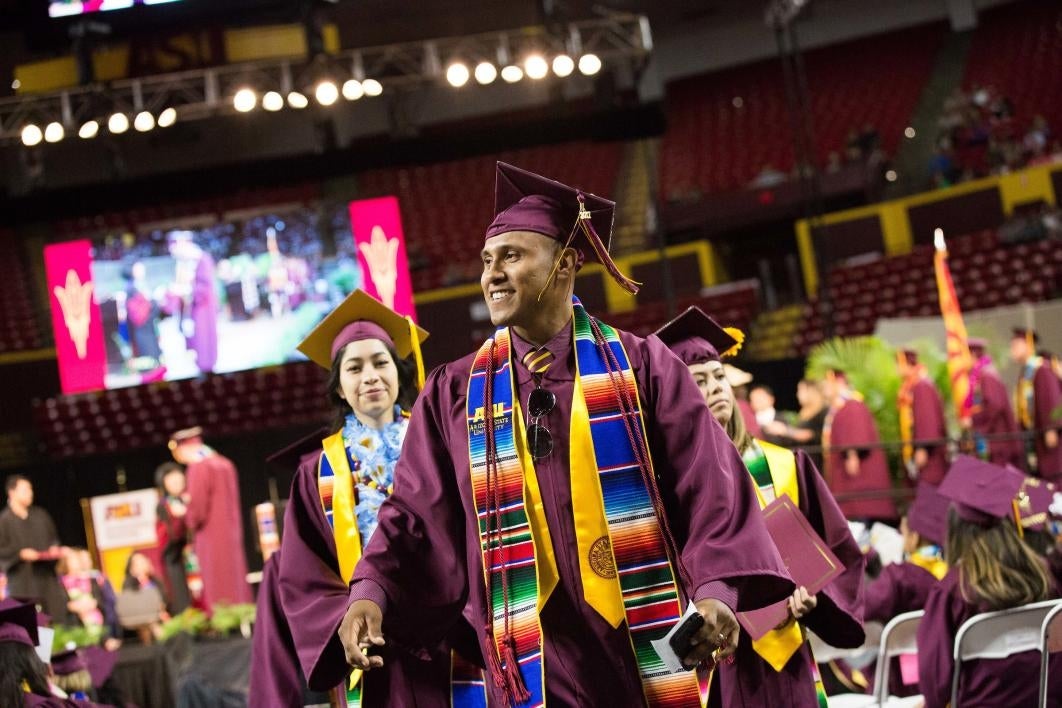 graduate walking off stage at convocation