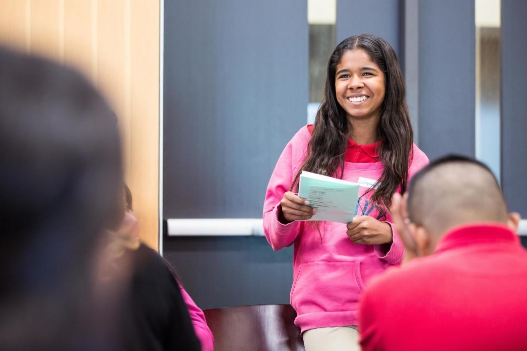 girl reading to class