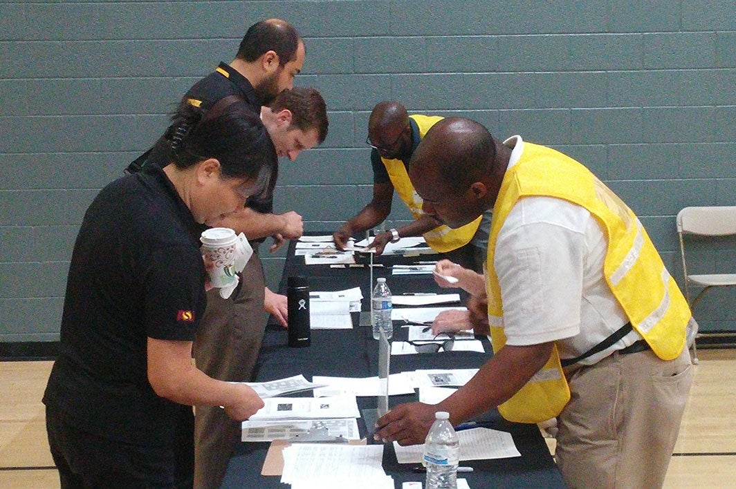 Team members check in for a cyberattack emergency drill in Tempe