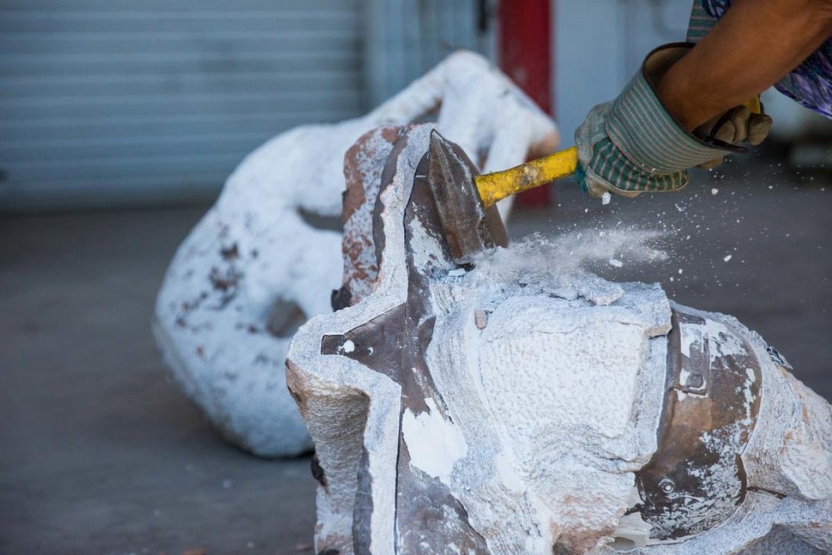 Breaking the mold shape off the bronze bust of Pat Tillman