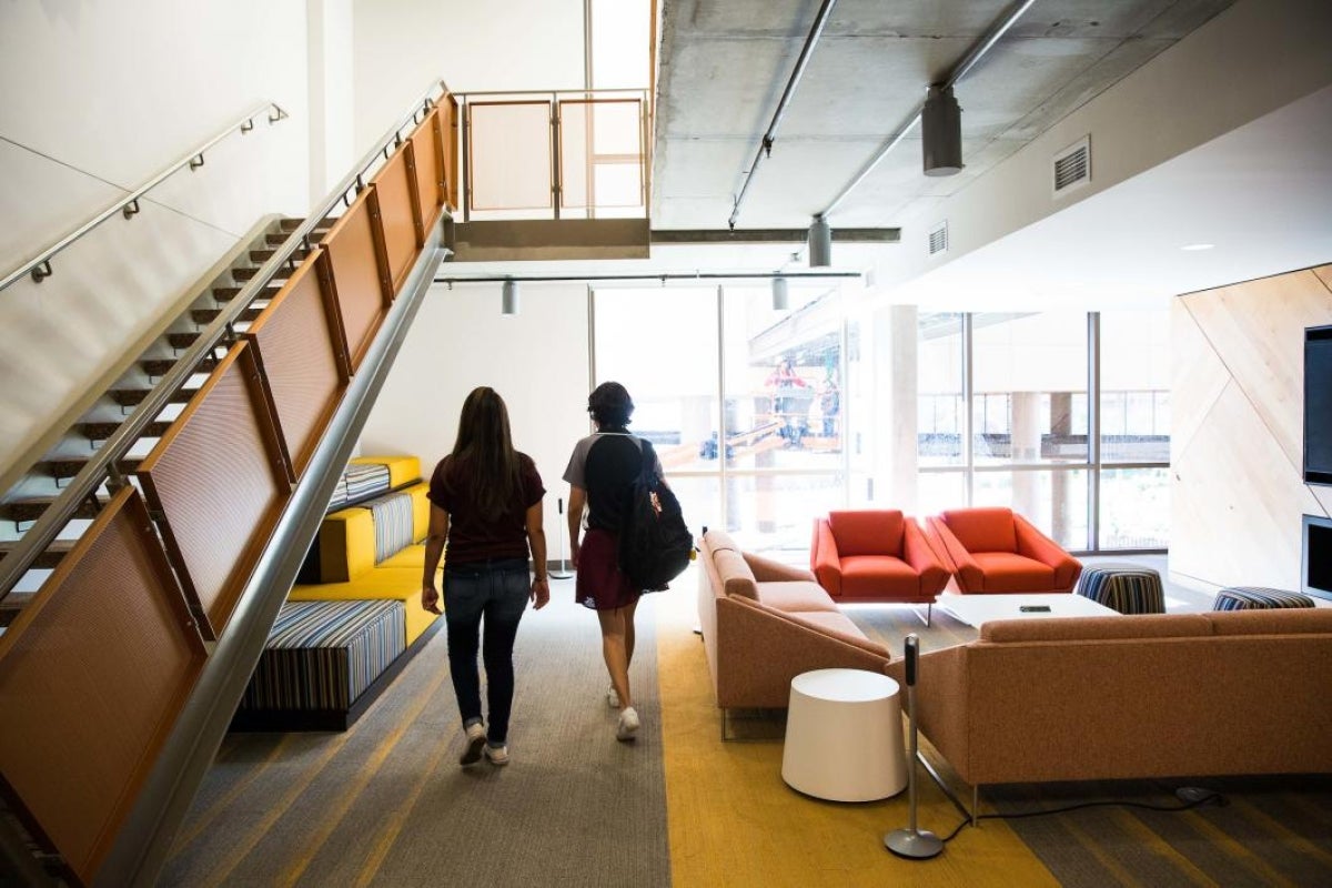 Students walk through a social area at Tooker House