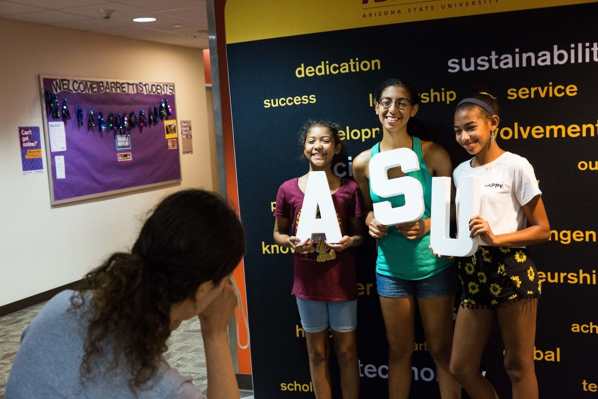 A student and her sisters pose for a photo at the Polytechnic move-in