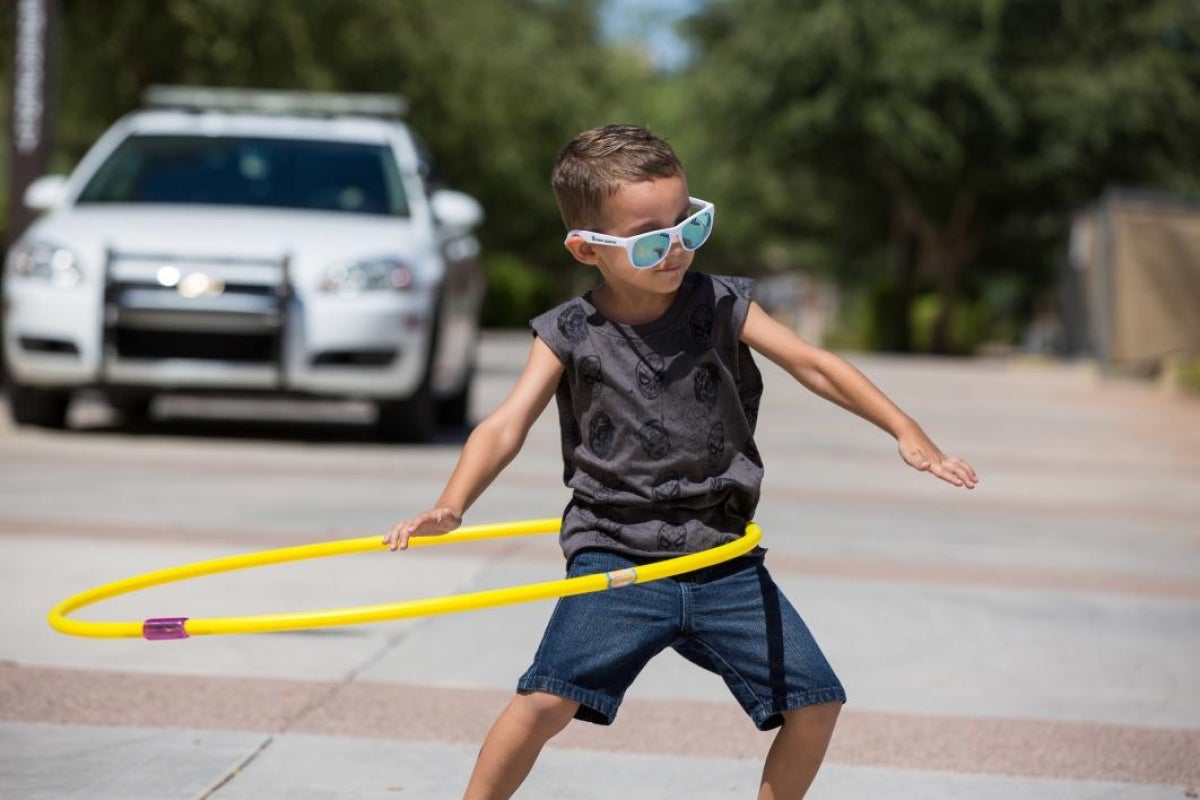 A boy plays with a hula hoop