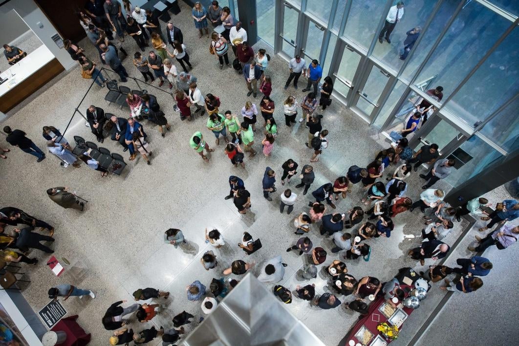 overhead view of crowd of people in building for grand opening