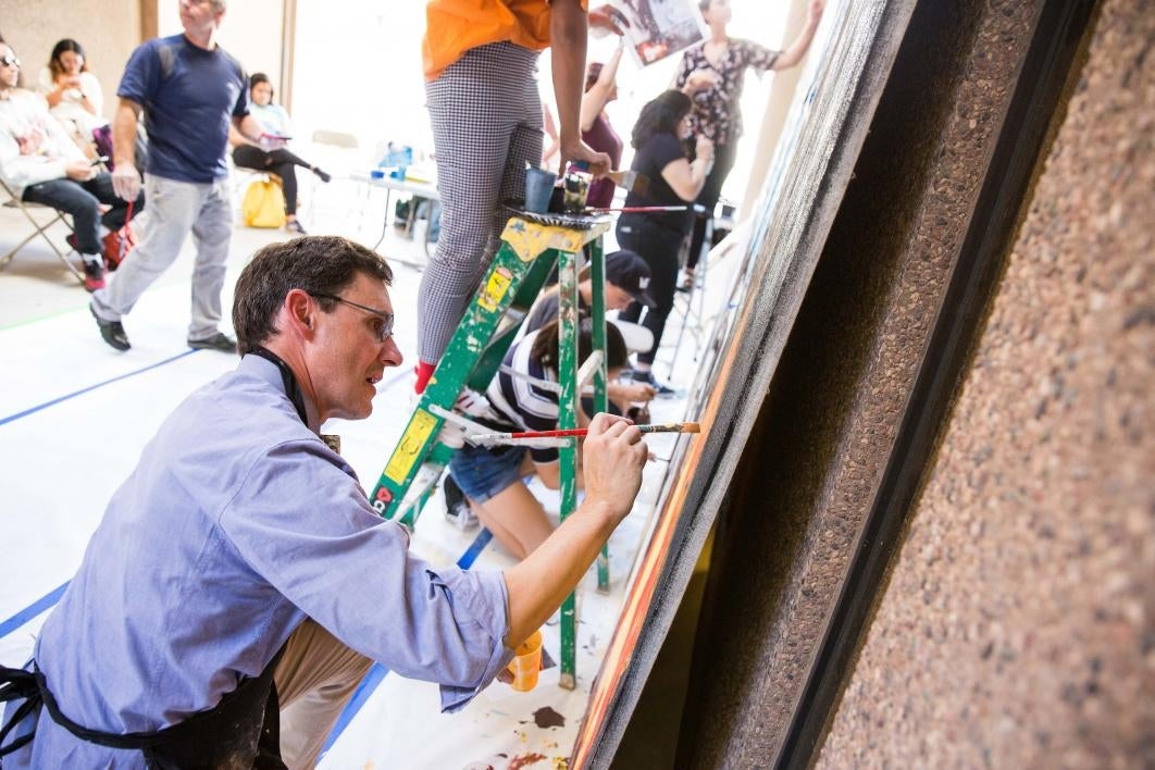 The dean paints a mural during Herberger Institute Day