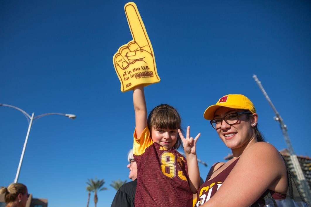 parent holding child at ASU Homecoming