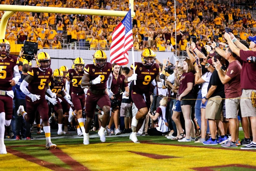 football players running out on to field