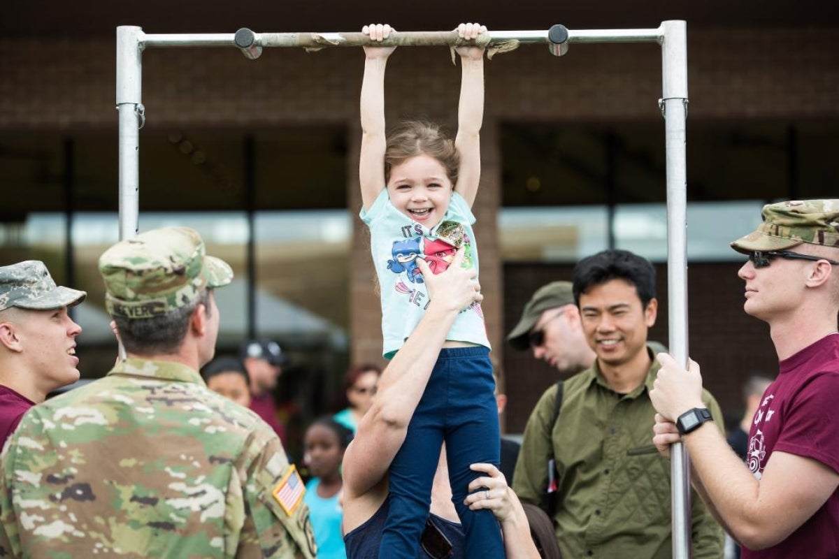 child practicing pull-ups