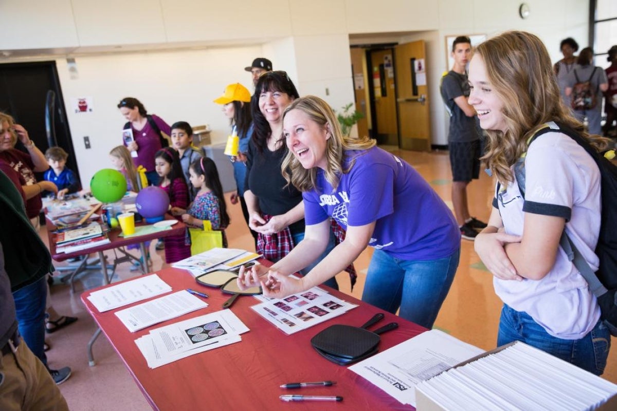 women teaching attendees about tendons in hands