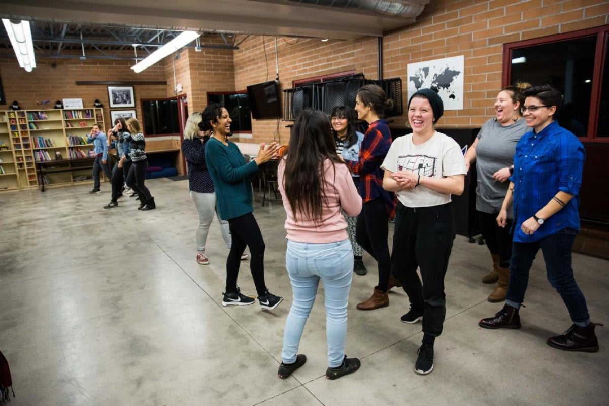 participants laugh after finishing their dance